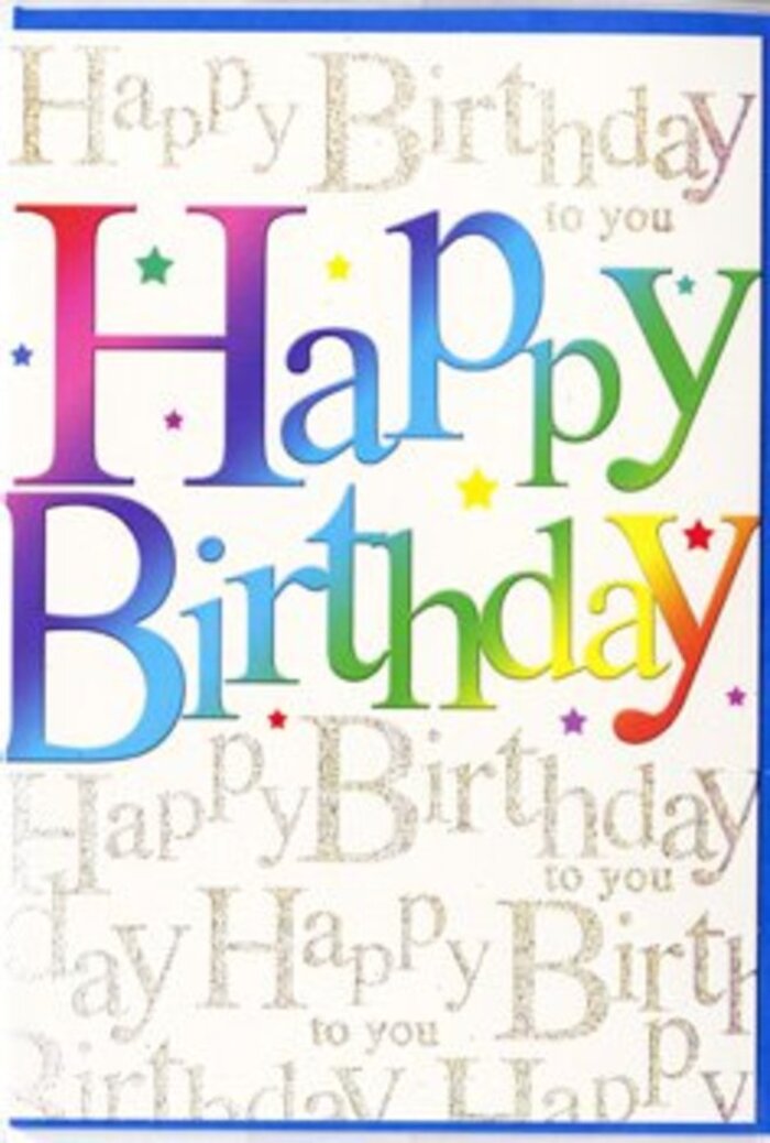 The photograph shows a striking birthday card propped up so that its full front design is visible, glowing with celebratory colour that would look perfectly at home in a cheerful Hornsey café window. The main focus is the bold Happy Birthday message stretched across the centre, written in large, friendly letters that have a slightly rounded, playful style. Each letter is filled with a smooth, velvety gradient that travels through the full spectrum of a rainbow, shifting from deep reds and berry tones into fuchsia, indigo, and teal, before melting into fresh lime, soft citrus, and butter-yellow shades. The colour transitions are silky and seamless, evoking the blended hues of a well-curated bouquet from Flowers Hornsey, where each stem is chosen to create a harmonious whole. Behind this confident front text, the entire background is layered with repeated lines of Happy Birthday to you in delicate, looping script. The script appears in fine gold, with the look of metallic foil or glittering ink, and it runs diagonally across the card at a gentle angle, creating a sense of movement, as though the words are drifting upward like voices in a birthday song near Alexandra Palace on a breezy day. The calligraphy is small enough that it becomes more of a shimmering pattern than something you'd read line by line, adding texture and a touch of sophistication. Tiny glints of light and micro-star shapes are scattered among the letters, contributing a confetti-like sparkle without crowding the main message. The card surface looks smooth and high-quality, with a soft sheen that suggests a pleasant tactile feel when held. Altogether, the design balances exuberance and elegance, making it an ideal companion to a fresh birthday arrangement delivered across the N8 area, for anyone who deserves a celebration that feels both colourful and heartfelt.